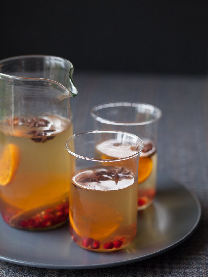 A recipe for Spiced White Wine Sangria with cinnamon sticks, star anise, and tangerines. 
