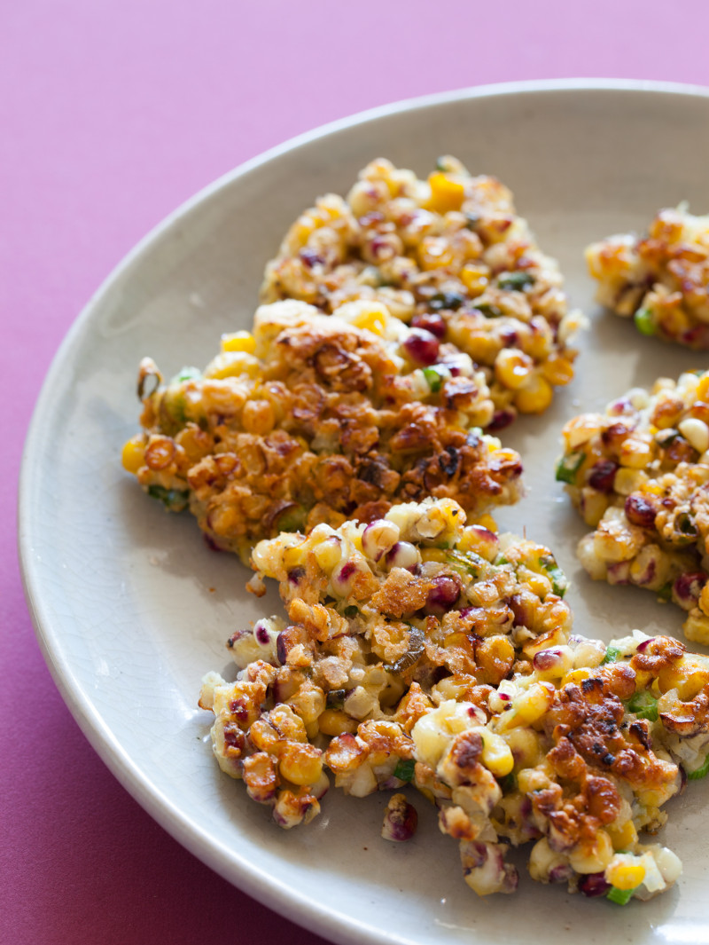 A close up of a plate of crispy corn cakes.