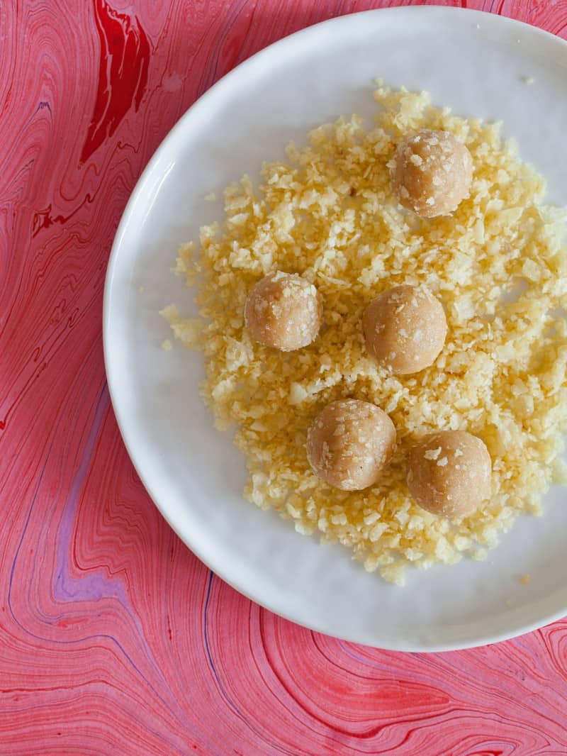 Cookie dough for Peanut Butter and Jelly Thumbprint Cookies rolled in crushed potato chips.