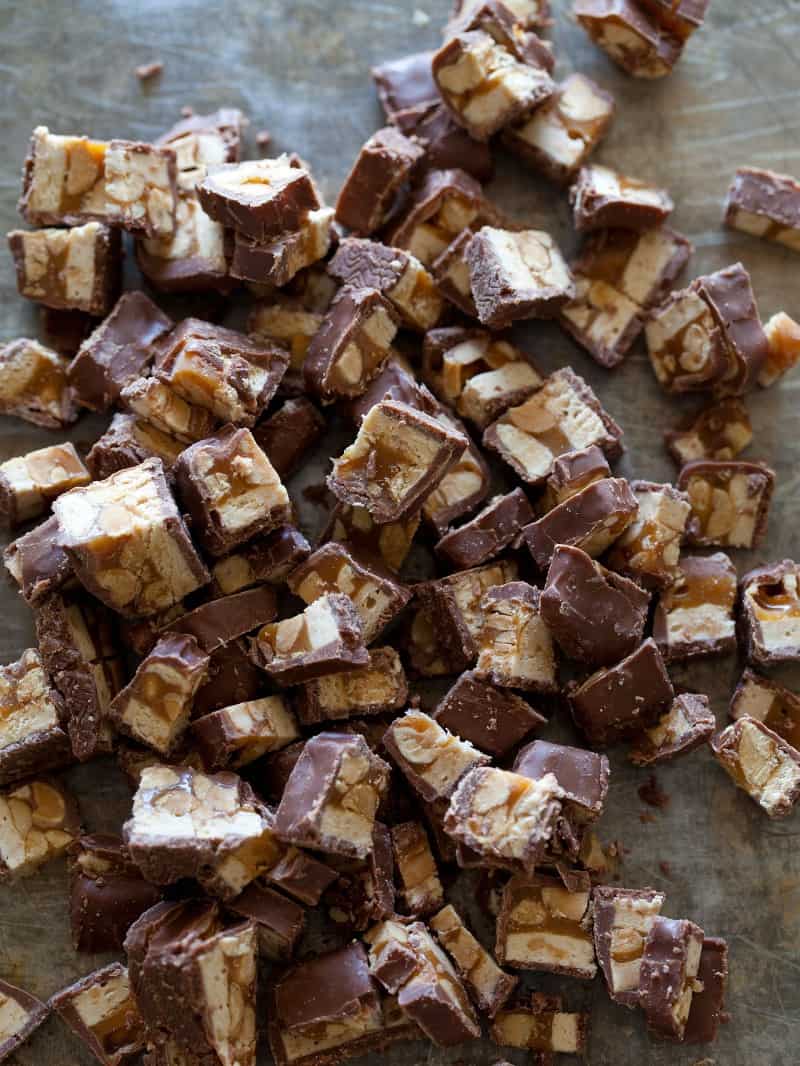 A close up of chopped up Snickers bars for a Snickers milkshake.