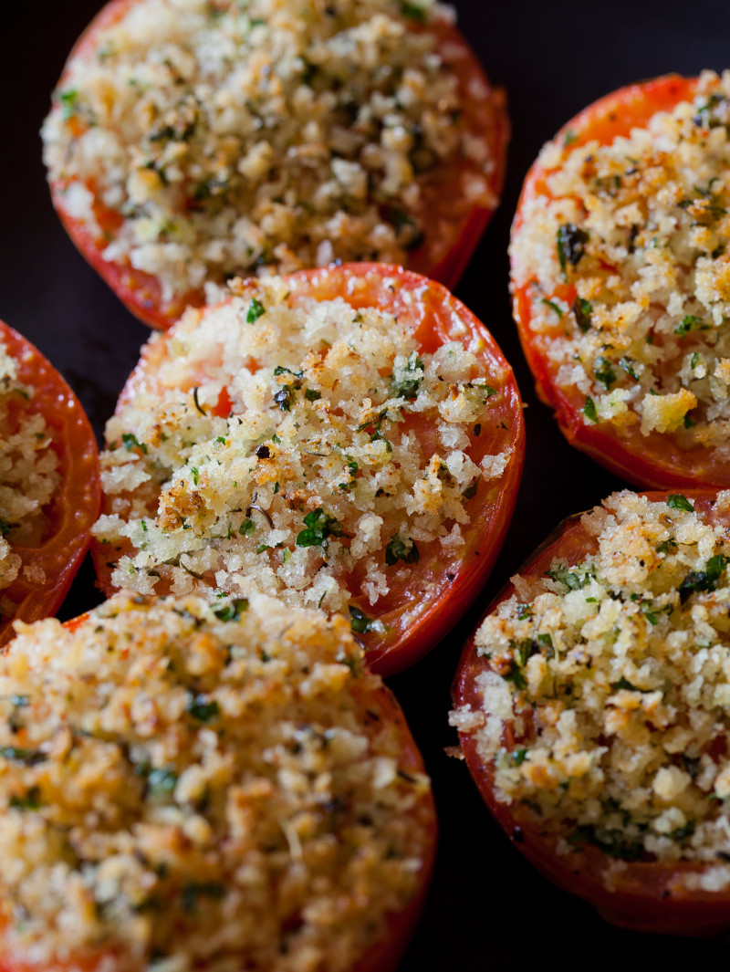 A close up of herb and panko crusted baked tomatoes. 