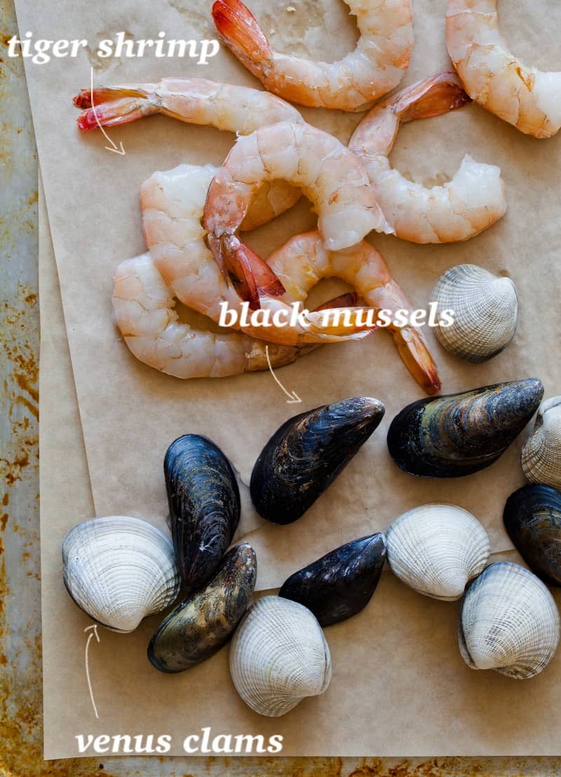 Paella ingredients, tiger shrimp, black mussels, and venus clams.