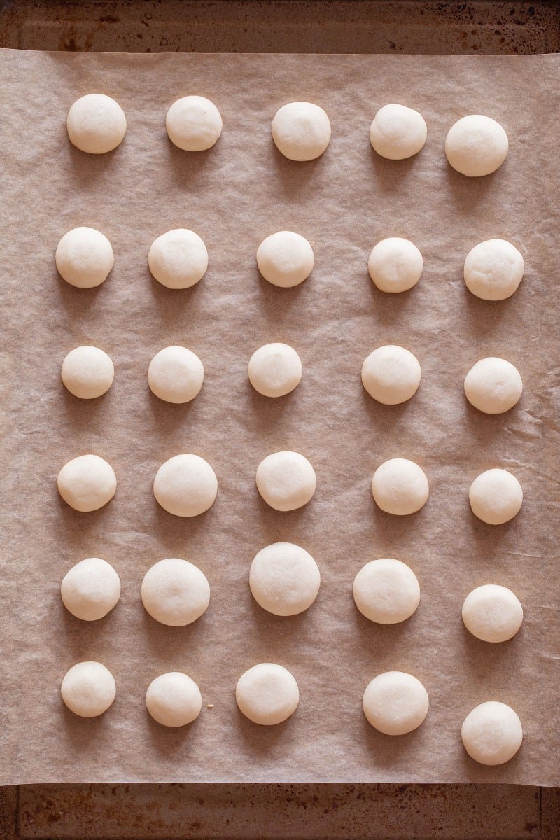 A grid of baked off cookies for baci di dama.