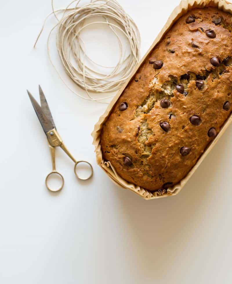 Banana bread gift packaging with scissors and twine.