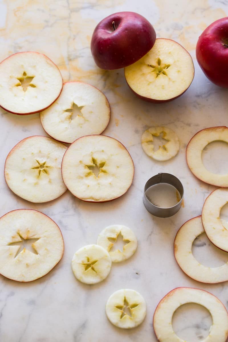 Thin slices of apples cut our for a Honeycrisp and Bourbon Spiced Cider cocktail recipe.