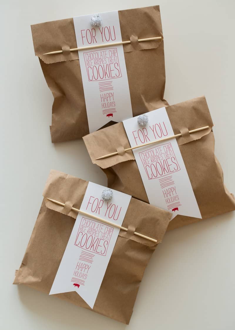 A close up of holiday cookie gift bags with pick closures and tags.