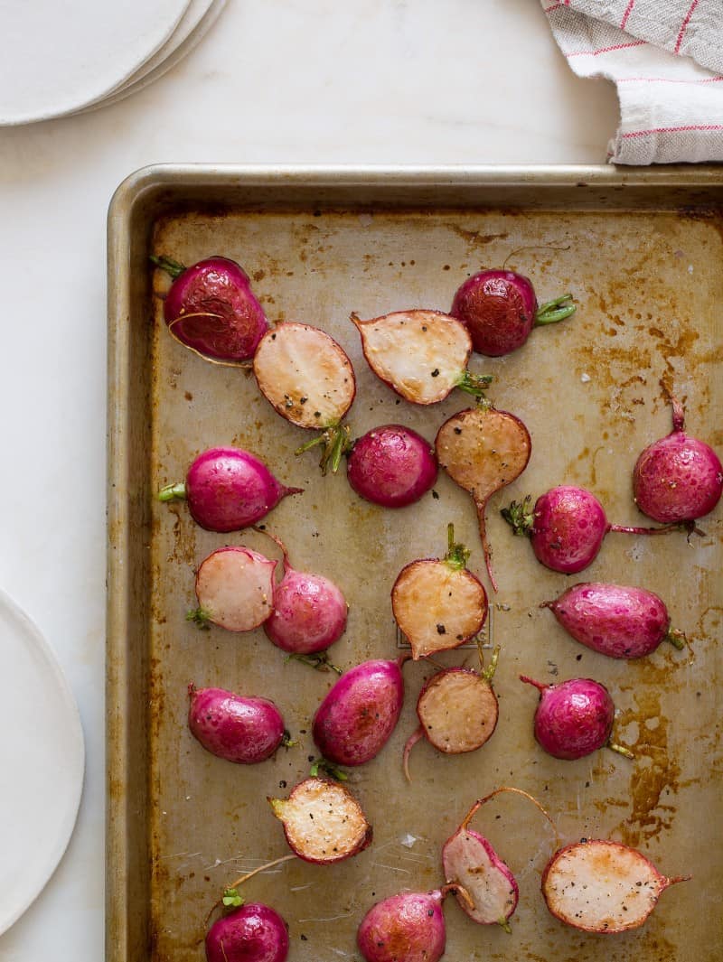 Roasted radishes on a sheet pan.