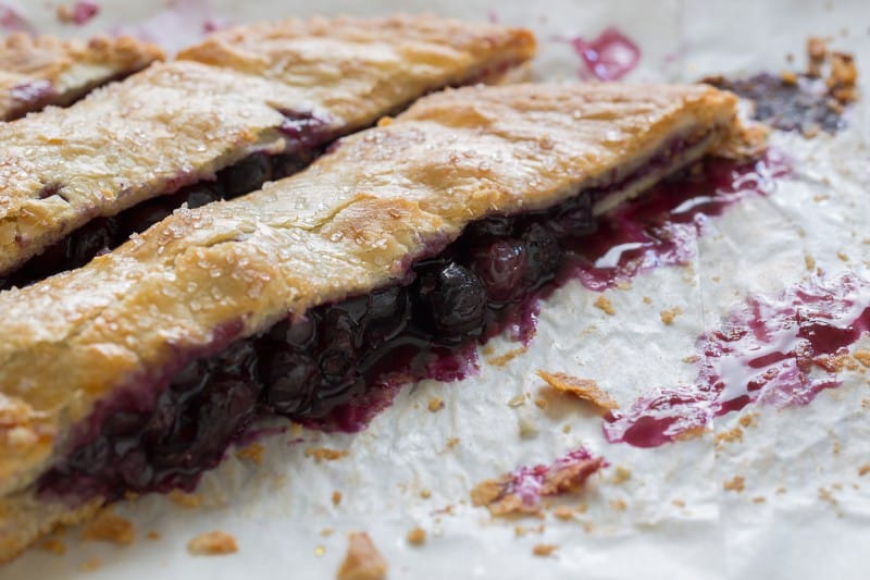 A close up of a bias cut blueberry slab pie.