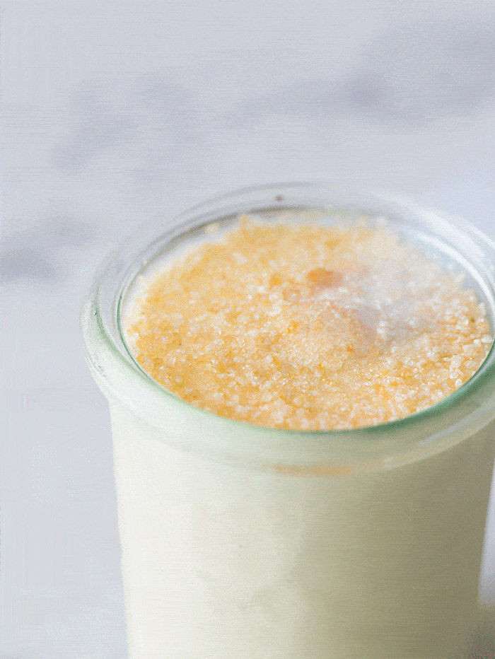 A torch burning the top of a jar of creme brûlée frozen custard.