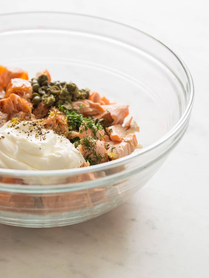 A close up of a bowl of ingredients for salmon rillettes ready to be mixed.