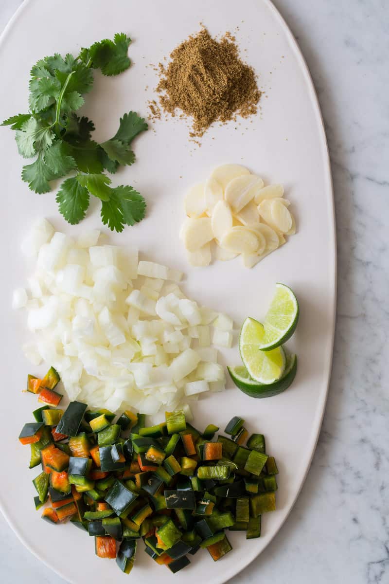 A plate of ingredients for spicy black bean soup minus the beans.