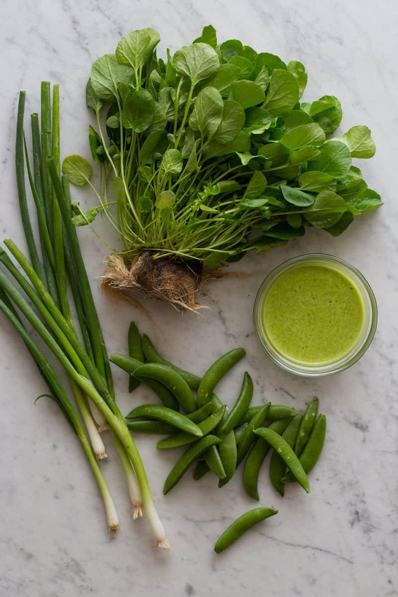 Ingredients for watercress salad with a bowl of green apple vinaigrette.