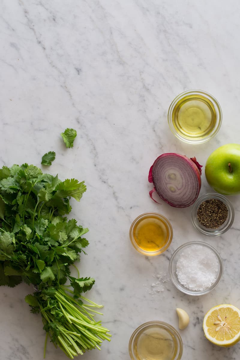 Ingredients for green apple vinaigrette on a marble countertop.