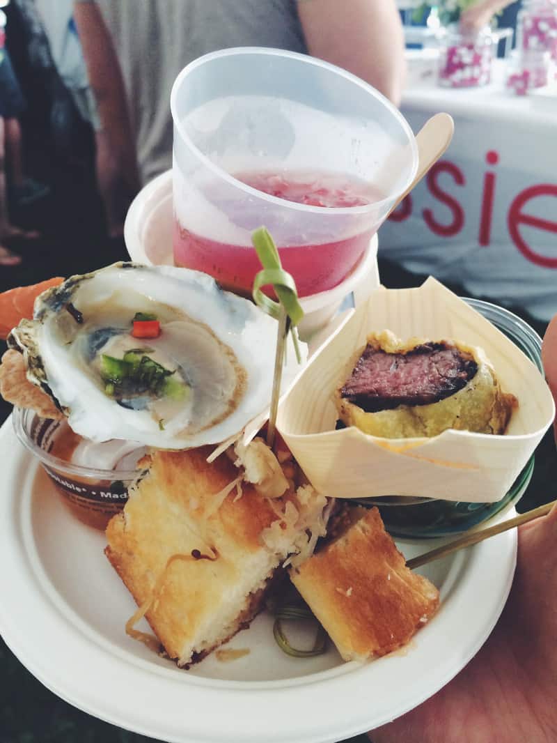 A close up of a plate of food and a pink drink.