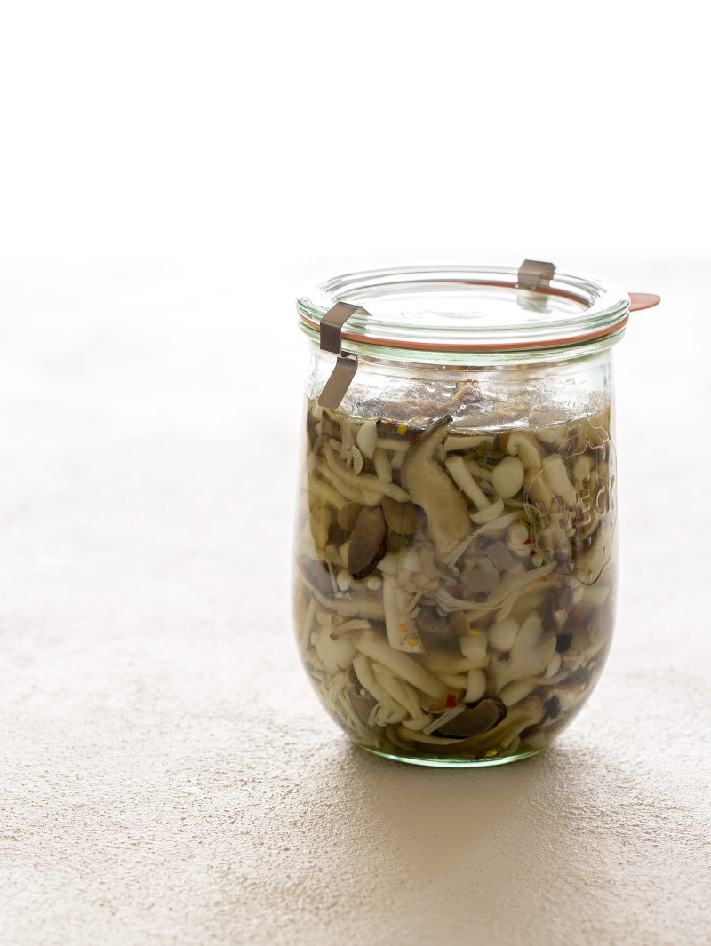 A jar of pickled mushrooms.