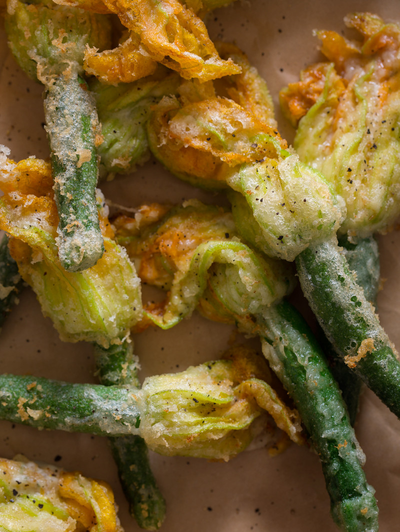 A close up of stuffed and fried squash blossoms.