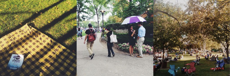 A group of people walking down a sidewalk holding an umbrella.