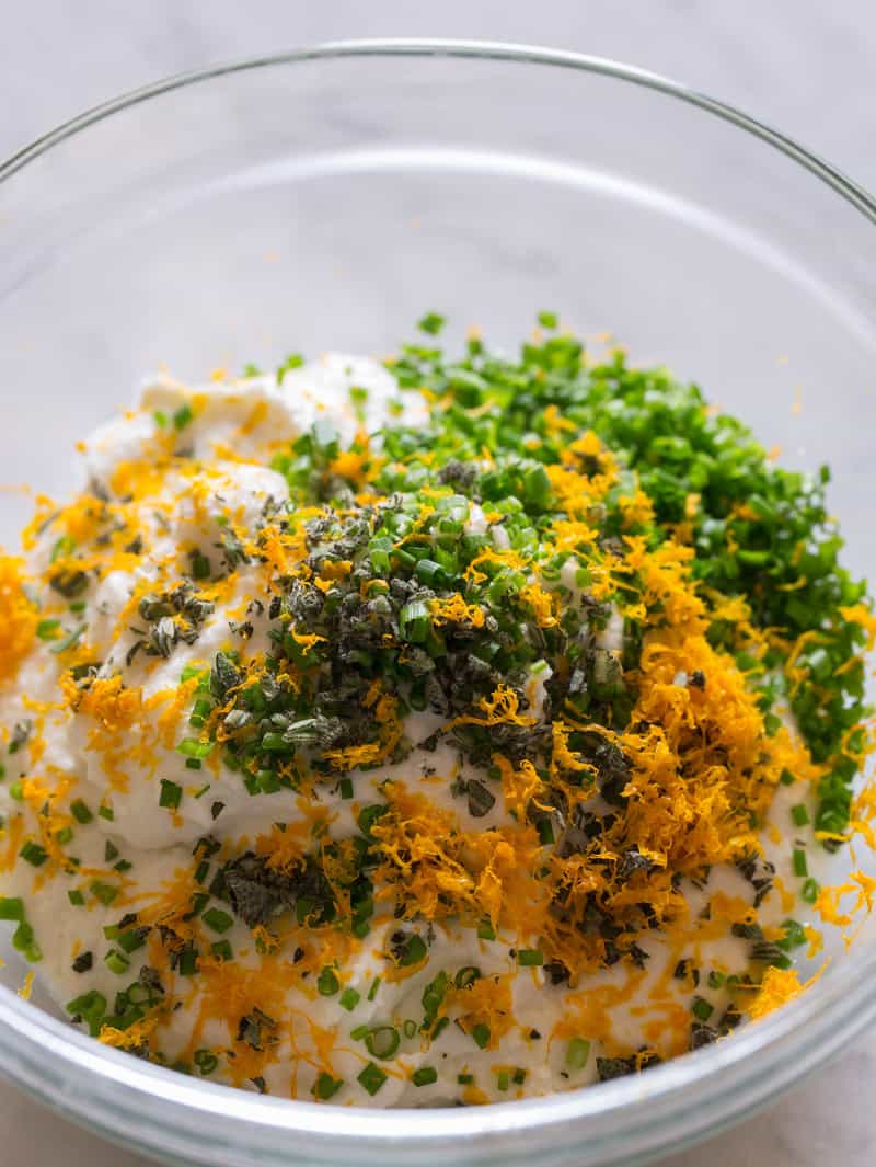 A bowl of ingredients for stuffed and fried squash blossoms.