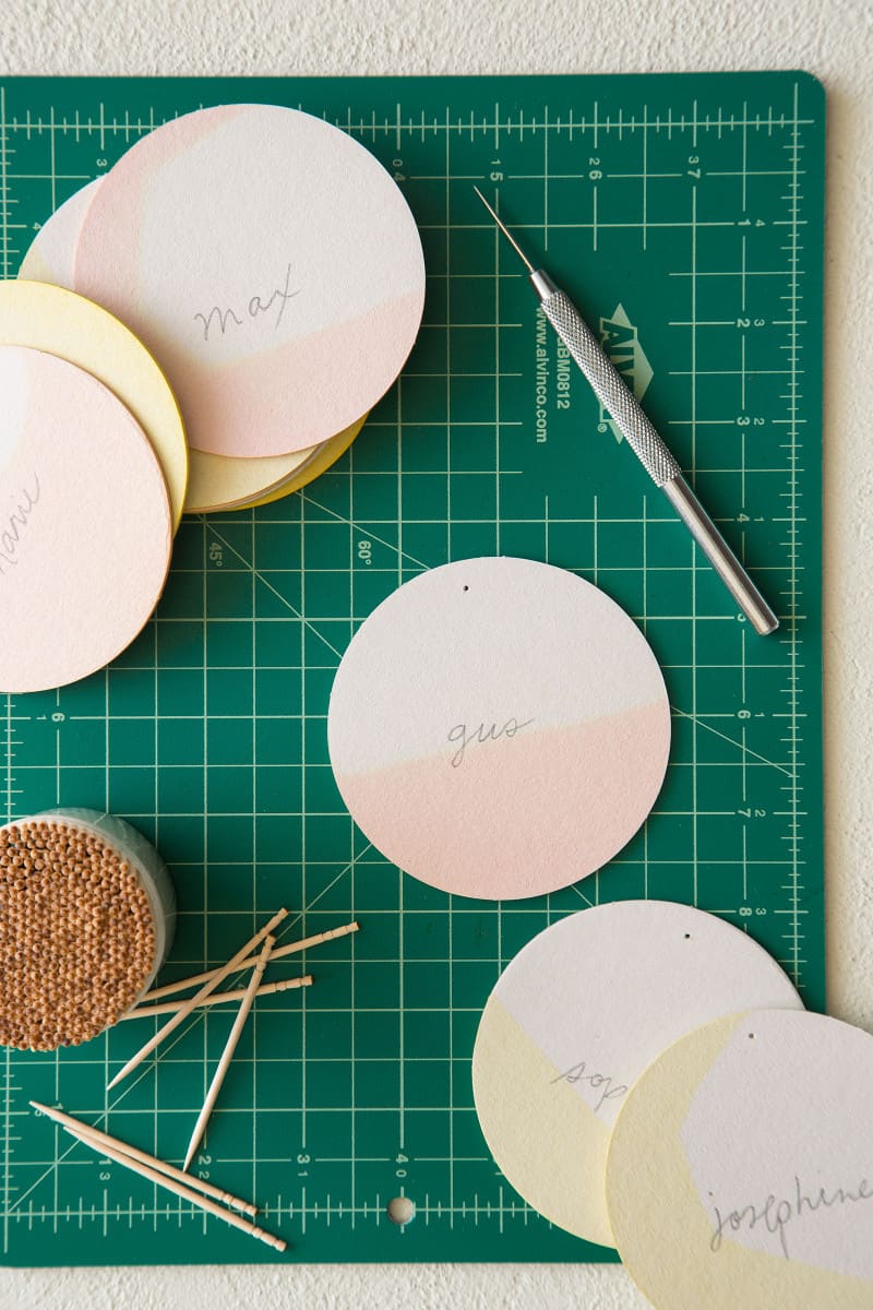 DIY dip dye place cards on a cutting mat with tooth picks and and awl.