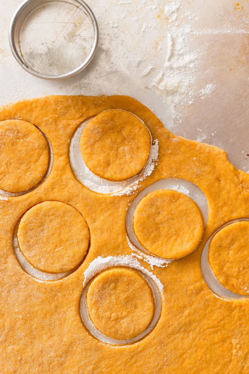 Pumpkin crème brûlée doughnut dough cut out in circles.