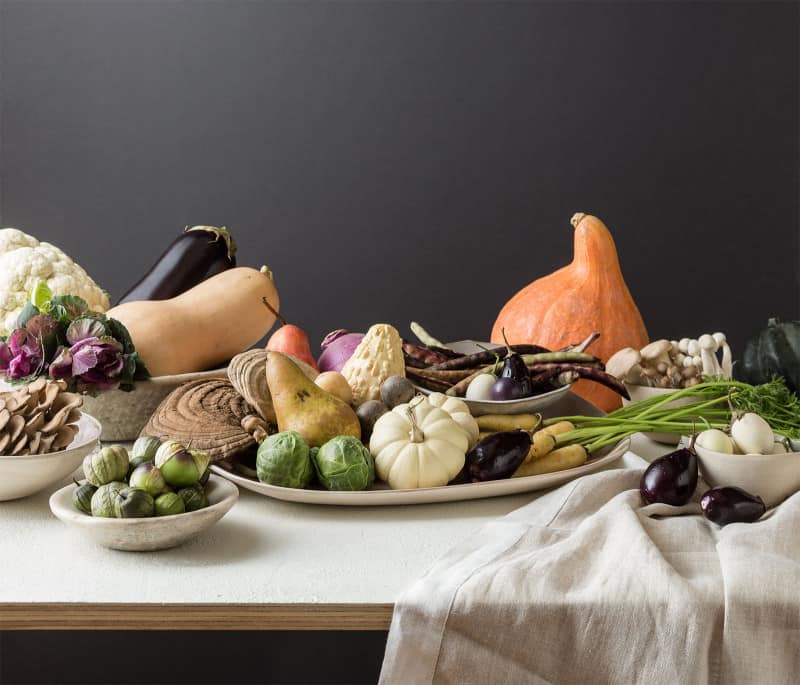 A flowerless Thanksgiving centerpiece made with a variety of fruits and vegetables.