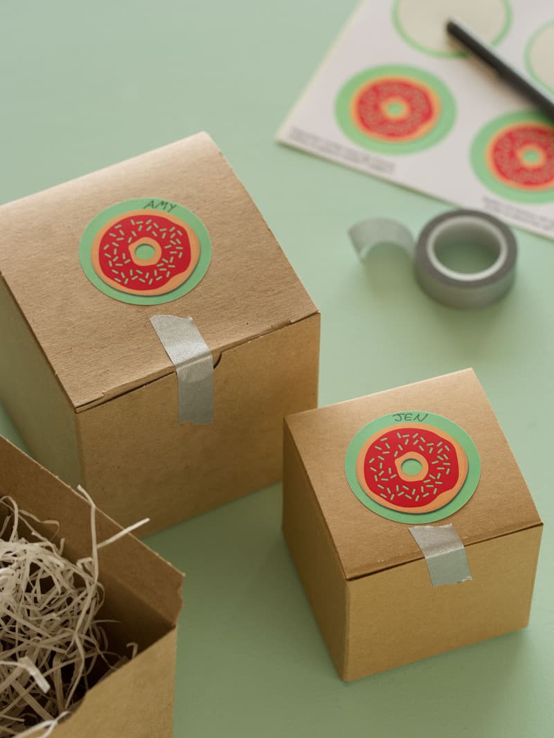 Doughnut printable food gift tags on gift boxes with tape.