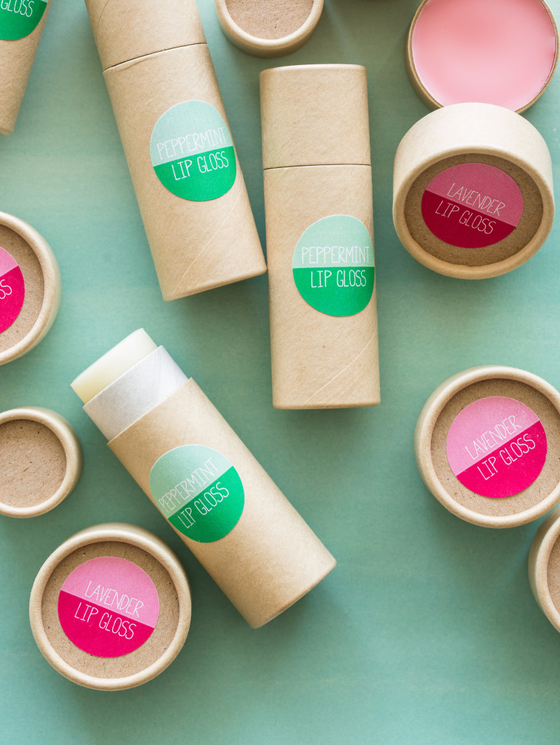 Two different types of DIY lip gloss with green and pink labels.