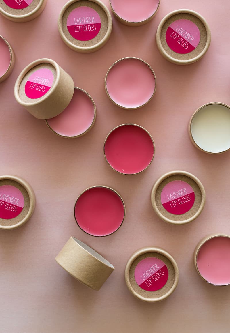 Pink lavender lip gloss in containers and labeled.