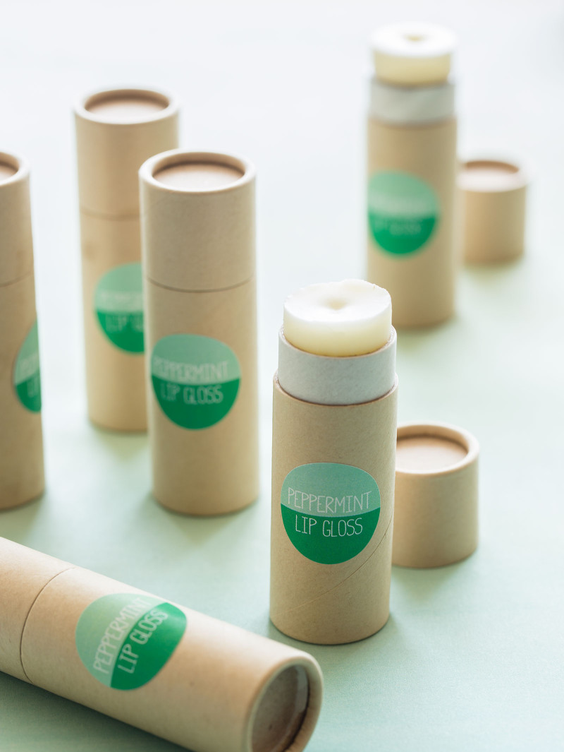 A close up of peppermint lip gloss in containers and labeled.