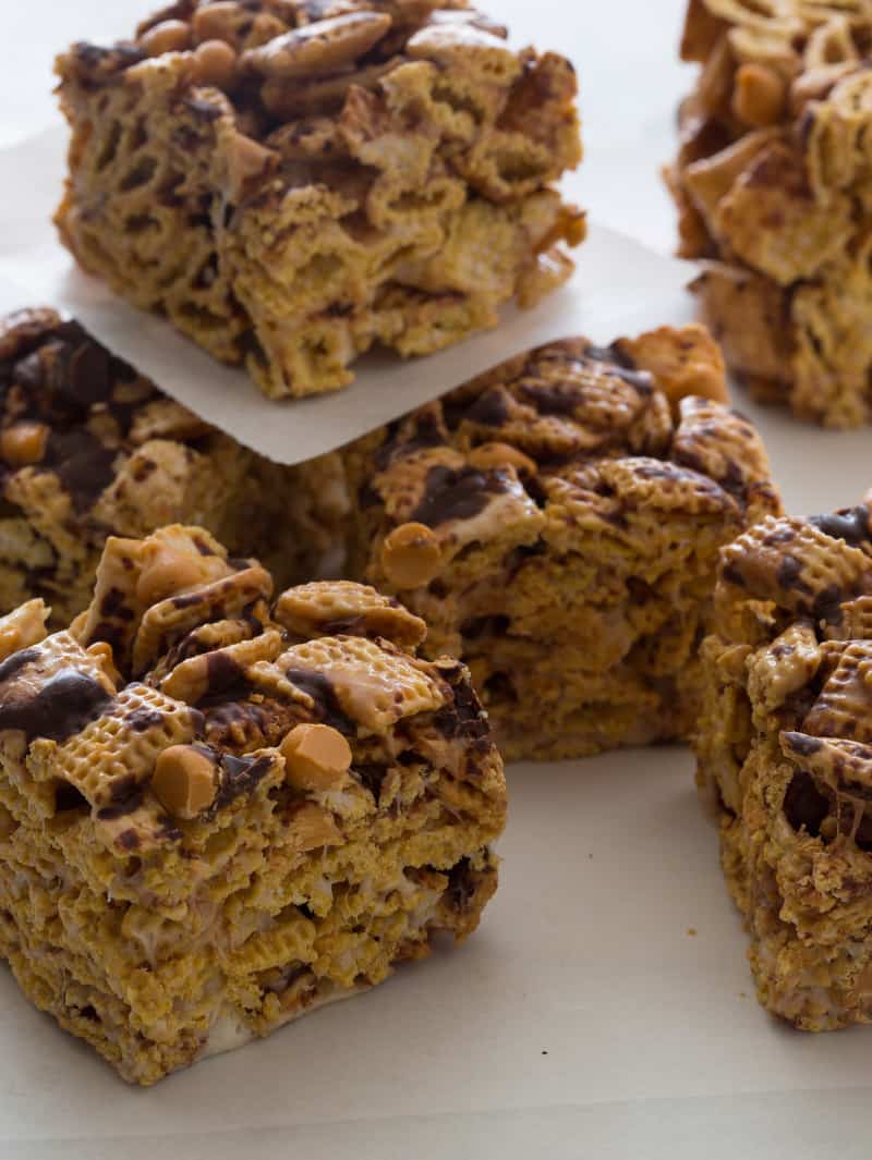 A close up of dark chocolate, butterscotch, and corn Chex cereal treat squares.