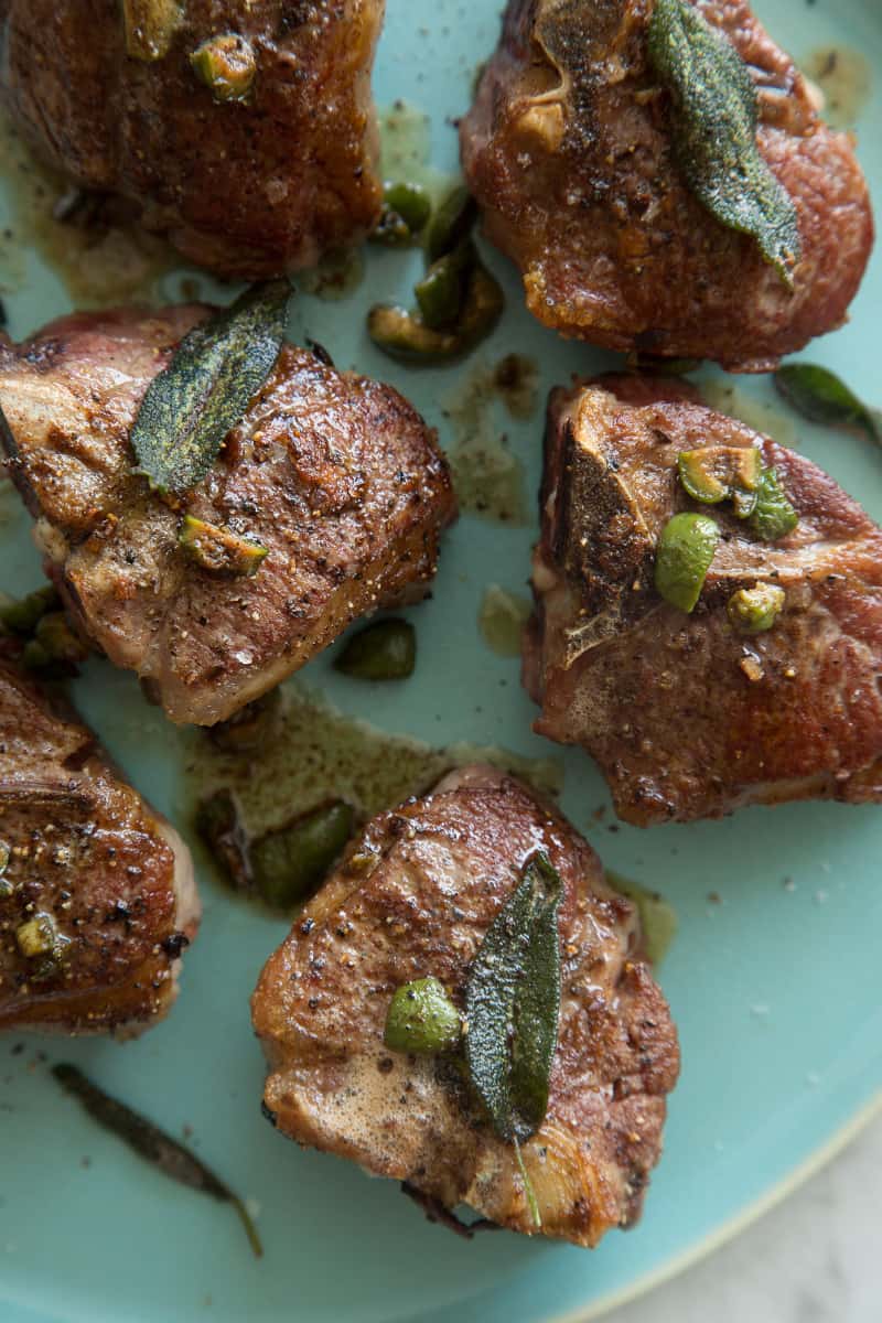 A close up of garlic and anchovy roasted lamb chops.