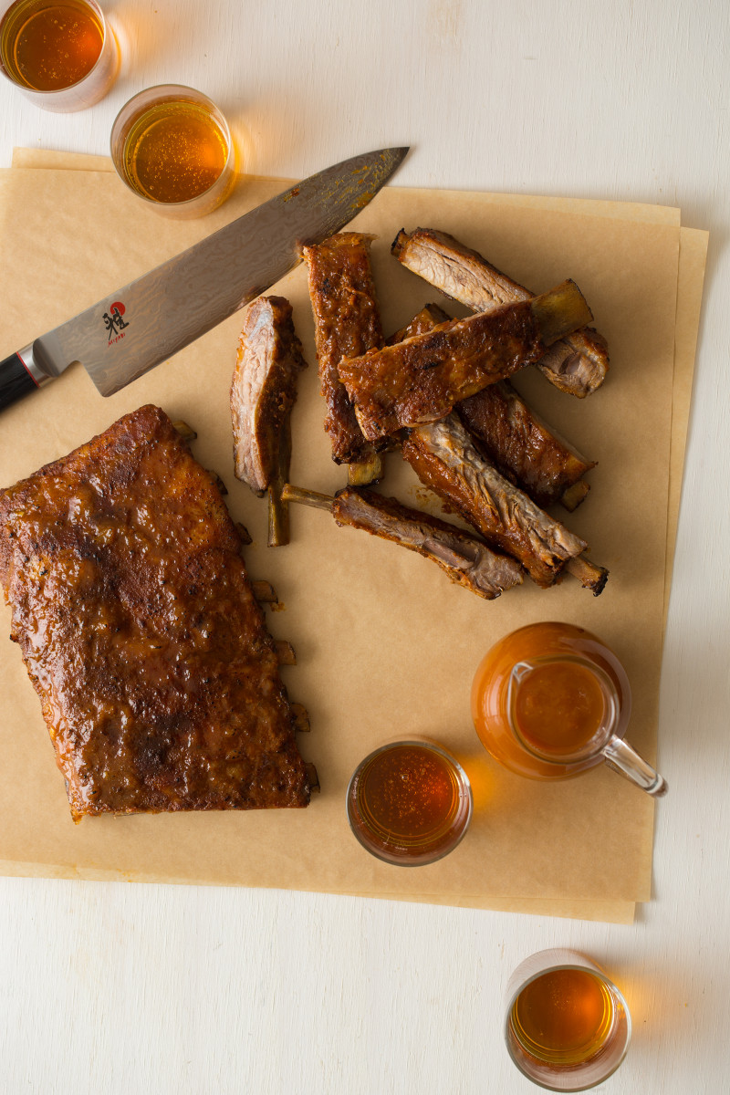 Habanero glazed spare ribs rub up on pieces of parchment.