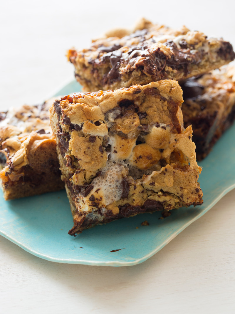 Sliced and stacked oatmeal s\'mores bars on a plate.