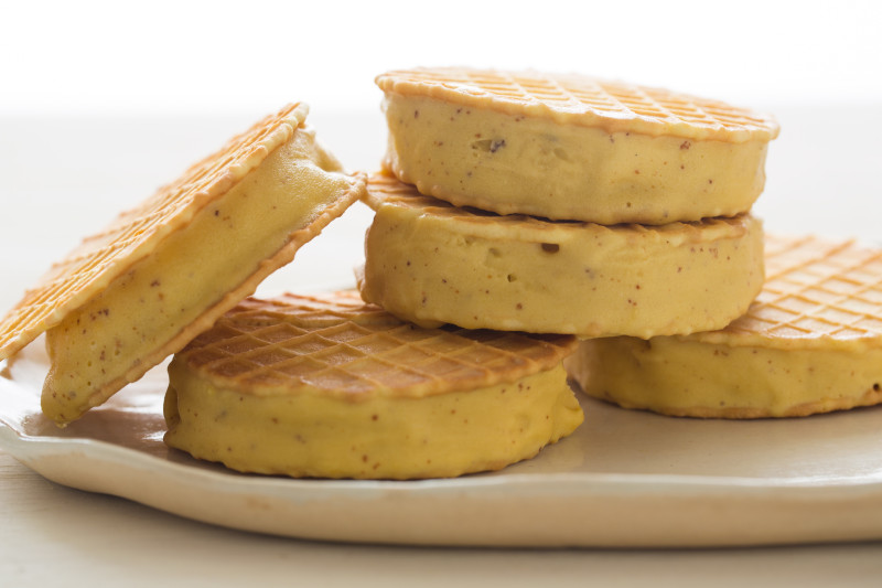 A close up of stacked browned butter ice cream sandwiches.