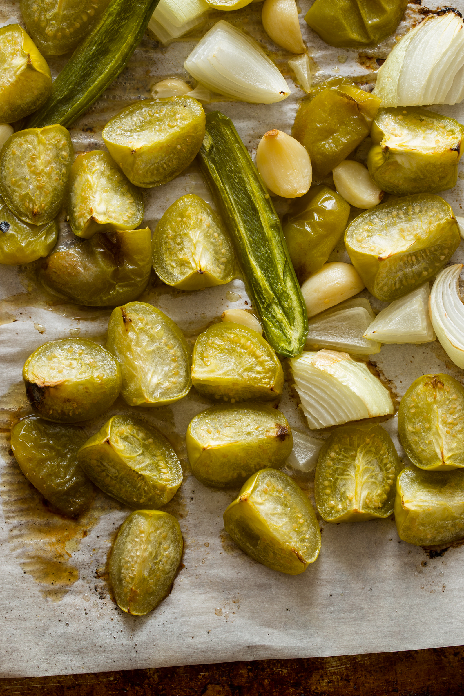 Roasted tomatillos on a baking sheet.