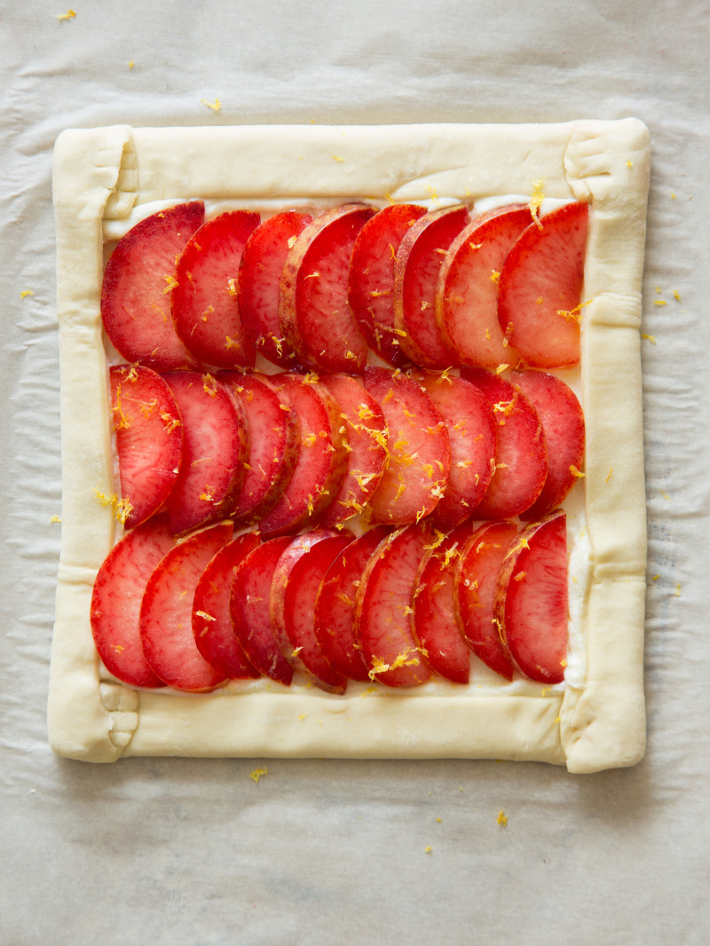 A stone fruit tart assembled and ready for baking.