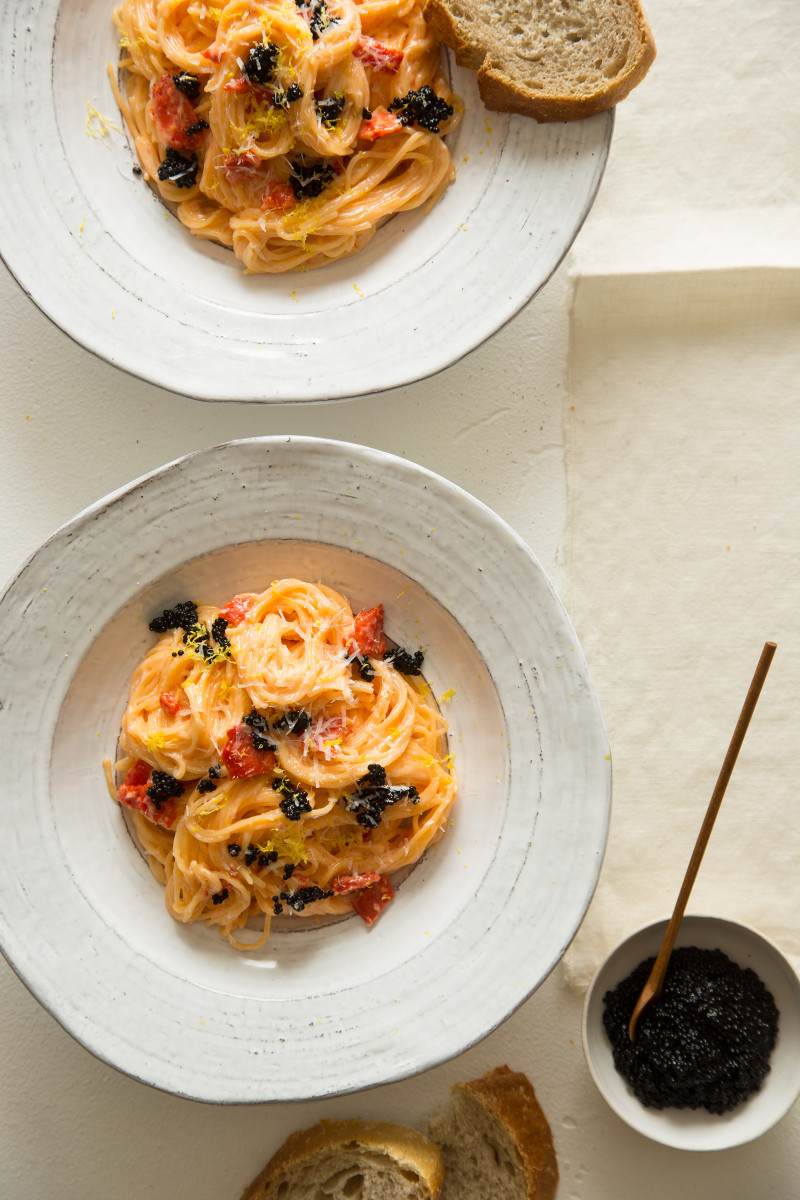 Bowls of capellini with a smoked salmon cream sauce.