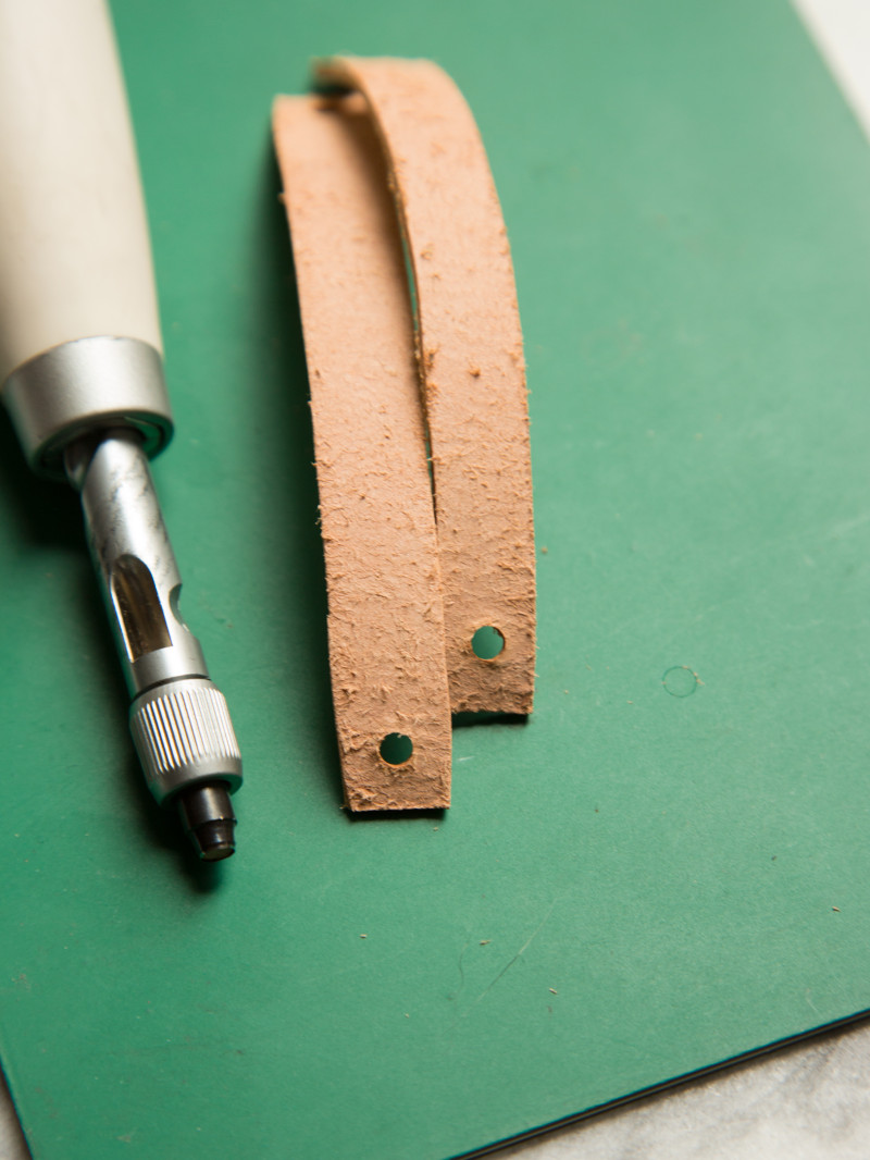 Leather strips with holes punched in the ends and a screw punch tool.