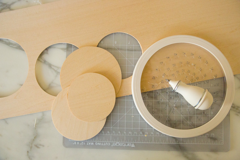 Wood circles cut out of a larger wood sheet with a circle cutter.