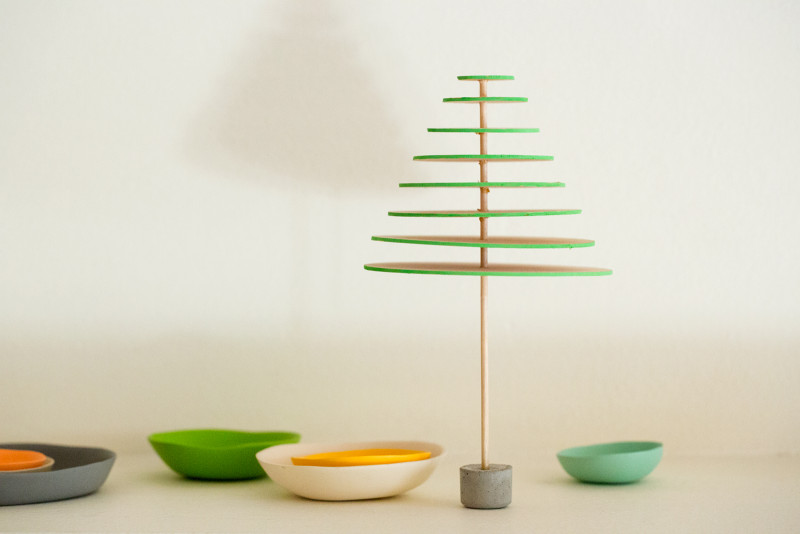 A DIY modern mini balsa wood Christmas tree with small bowls below.