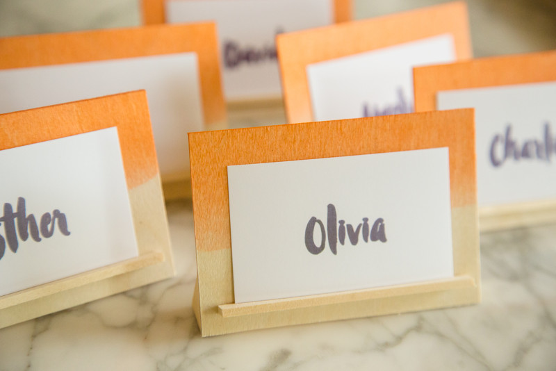 A close up of a DIY dip dye wood place card holders.