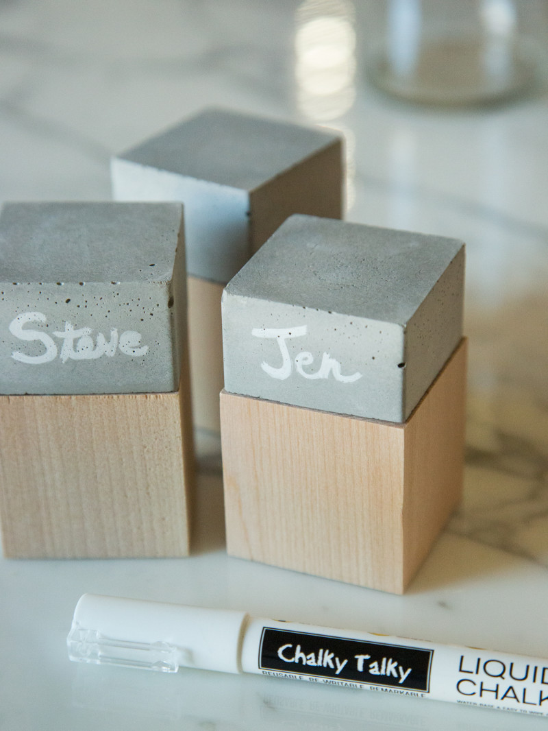 A close up of finished DIY cement and wood place cards.