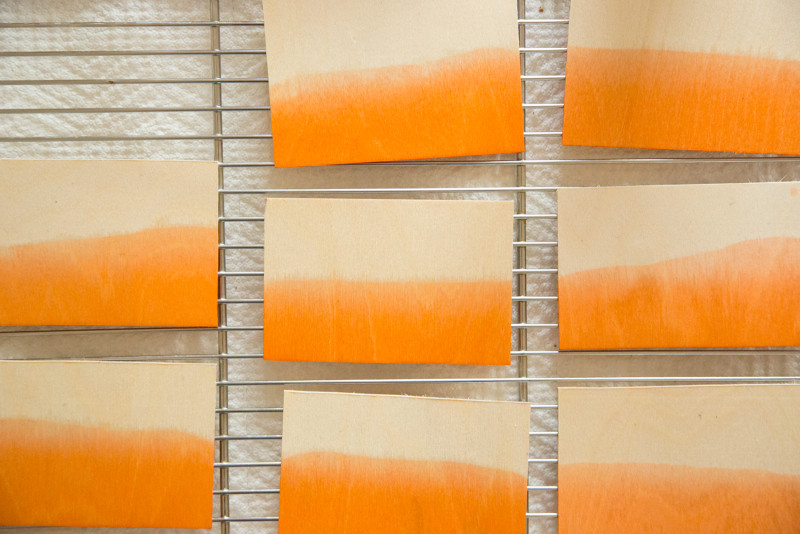 dipped balsa wood drying on a cookie rack