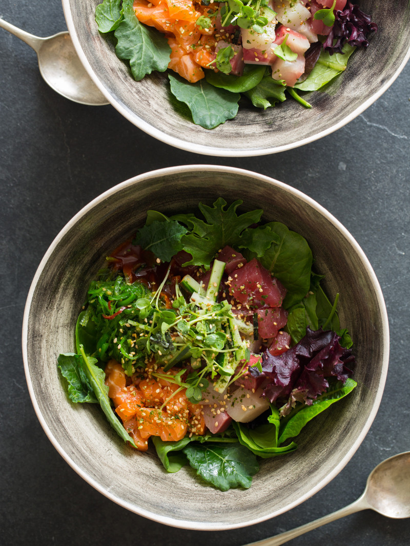 Korean spicy sashimi salad in gray bowls.