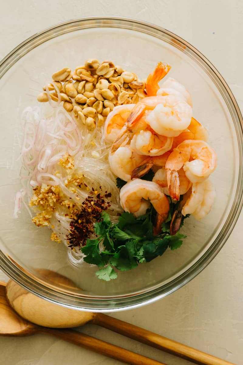 Ingredients for yum wood sen with shrimp in a glass bowl.