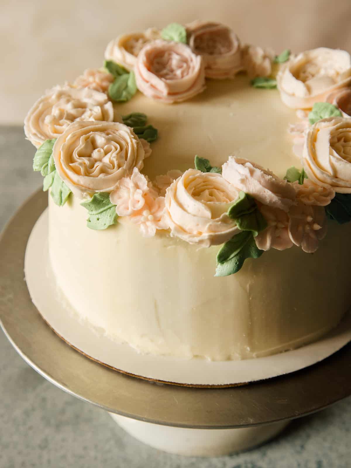 A close up of a whole floral wreath cake.