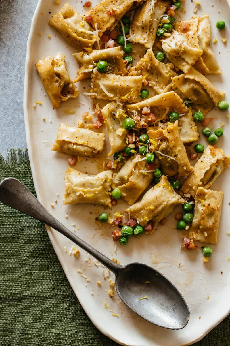 Creamy sweet pea pesto agnolotti with a spoon.