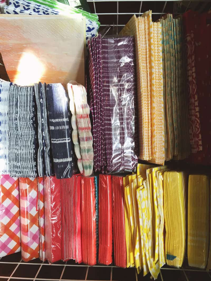 A close up of different sized and colored paper napkins.