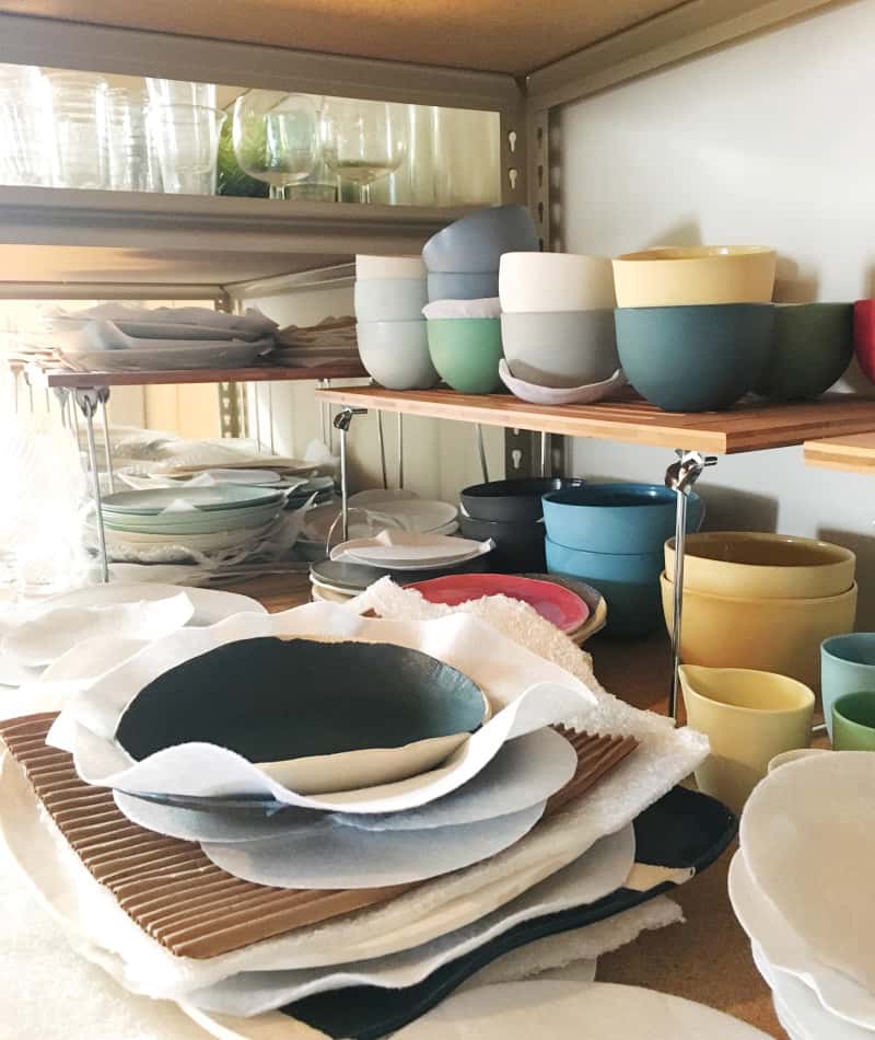 A close up of stacked bowls in different sizes and colors.