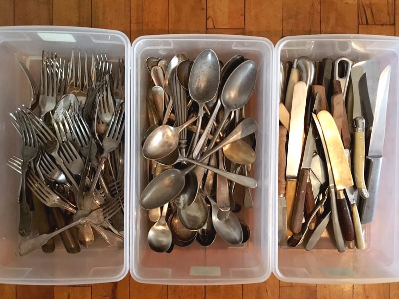 Three separate bins organized by forks, spoons, and knives.